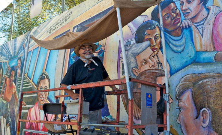 Man painting Great Wall of L.A. Restoration